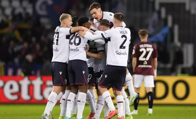 Bologna's Tommaso Pobega celebrates with teammates after scoring during the Serie A soccer match between Torino and Bologna, in Turin, Italy, Saturday, Dec. 21, 2024. (Fabio Ferrari/LaPresse via AP)