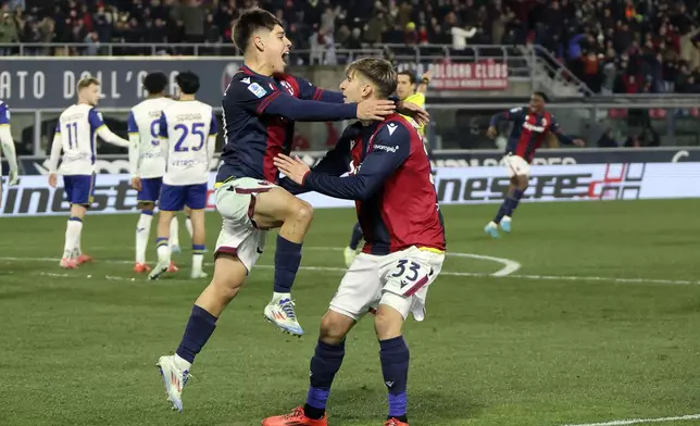 Bologna's Benjamin Dominguez, left, celebrates scoring during the Serie A soccer match between Bologna and Hellas Verona at Renato Dall'Ara Stadium, Bologna, Italy, Monday, Dec. 30, 2024. (Michele Nucci/LaPresse via AP)