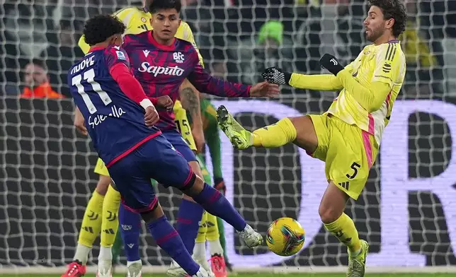 Bologna's Dan Ndoye fires a shot past Juventus' Manuel Locatelli, right, during the Italian Serie A soccer match between Juventus and Bologna at the Allianz Stadium in Turin, Italy, Saturday, Dec. 7, 2024. (Spada/LaPresse via AP)