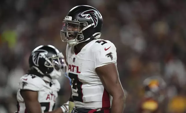 Atlanta Falcons quarterback Michael Penix Jr. (9) celebrates a touchdown during the second half of an NFL football game against the Washington Commanders, Sunday, Dec. 29, 2024, in Landover, Md. (AP Photo/Stephanie Scarbrough)