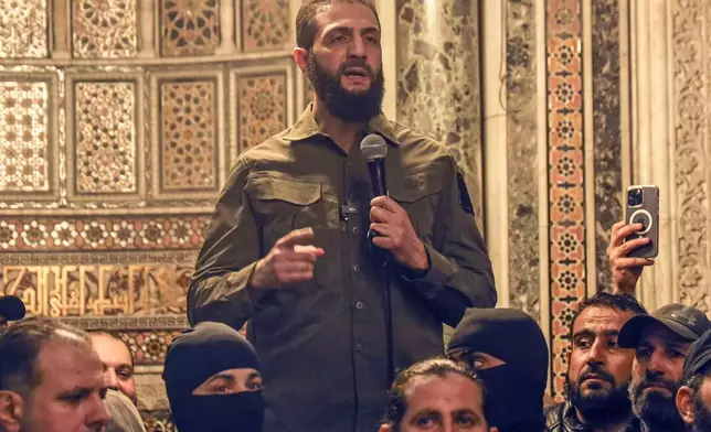 Abu Mohammed al-Golani speaks at the Umayyad Mosque in Damascus Sunday, Dec. 8, 2024. (AP Photo/Omar Albam)