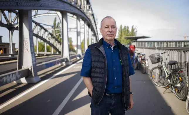 FILE -In this Sept. 4, 2019 photo, Frieder Reimold the former Berlin bureau chief of The Associated Press' German service poses for a photo at the bridge on Bornholmer Strasse during an interview with the Associated Press at the Berlin Wall Memorial side in Berlin, Germany. (AP Photo/Markus Schreiber, File)