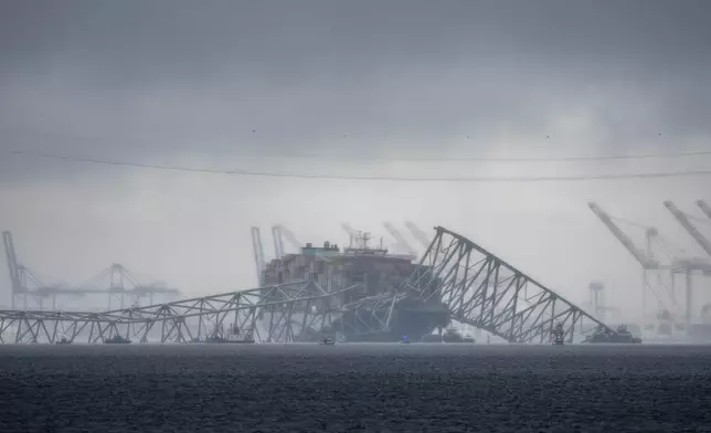 The container ship Dali rests against the wreckage of Baltimore's Francis Scott Key Bridge on the Patapsco River, on March 27, 2024, as seen from Pasadena, Md. (AP Photo/Alex Brandon)