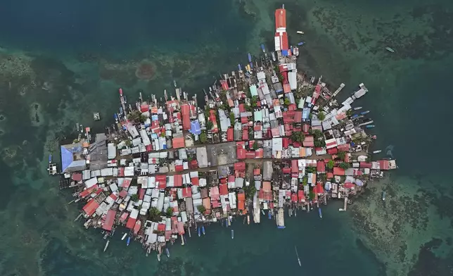 Buildings cover Gardi Sugdub Island, part of San Blas archipelago off Panama's Caribbean coast, on May 25, 2024. Due to rising sea levels, about 300 Guna Indigenous families are relocating to new homes, built by the government, on the mainland. (AP Photo/Matias Delacroix)