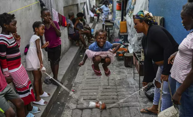 A girl plays a jump rope game at a school housing residents displaced by gang violence in Port-au-Prince, Haiti, on May 15, 2024. (AP Photo/Ramon Espinosa)