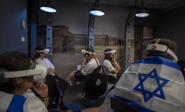 Israeli students watch a virtual tour of the concentration and extermination camp Auschwitz-Birkenau at the Testimony House, a Holocaust museum in Nir Galim, Israel, on the eve of Israel's annual Holocaust Remembrance Day, May 5, 2024. (AP Photo/Oded Balilty)