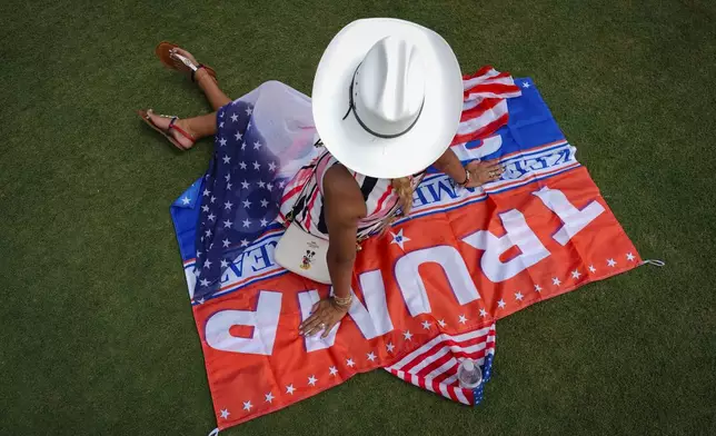 A supporter of Republican presidential candidate former President Donald Trump waits for the start of his campaign rally in Doral, Fla., on July 9, 2024. (AP Photo/Rebecca Blackwell)