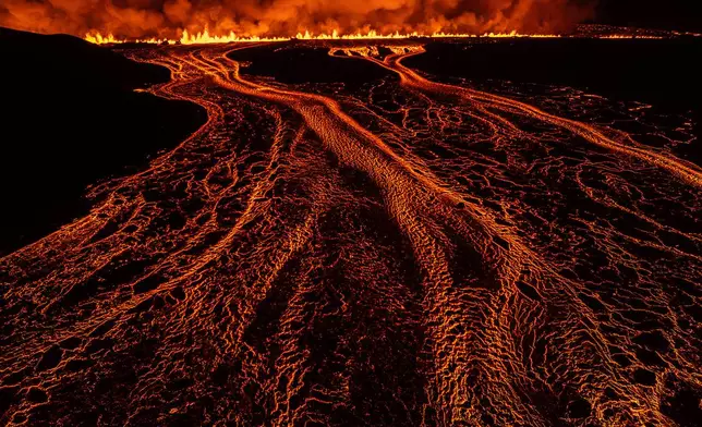 Lava flows from a volcanic eruption that started on the Reykjanes Peninsula in Iceland, Nov. 20, 2024. (AP Photo/Marco di Marco)