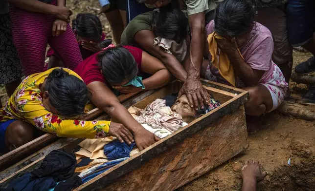 Maijuna mourners gather around the remains of Rosario Rios during her burial service in the cemetery of Sucusari, Peru, on May 29, 2024. (AP Photo/Rodrigo Abd)