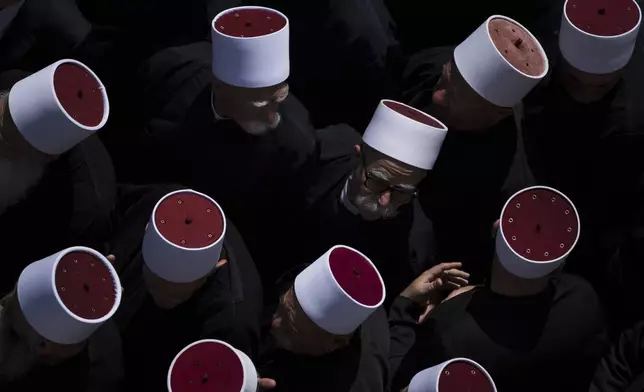 Druze clergymen attend the funeral of some of the 12 children and teens killed in a rocket strike by the Lebanese militant group Hezbollah at a soccer field at the village of Majdal Shams, in the Israeli-annexed Golan Heights, on July 28, 2024. (AP Photo/Leo Correa)