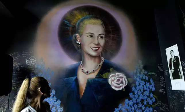 A mural of former Argentine first lady María Eva Duarte de Perón, better known as Eva Perón, or Evita, depicting her with a saint's halo, adorns a wall inside the Peron Peron restaurant in the San Telmo neighborhood of Buenos Aires, Argentina, Friday, Feb. 9, 2024. (AP Photo/Natacha Pisarenko)