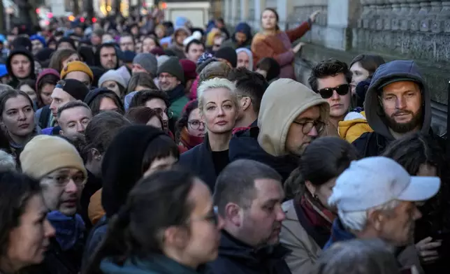 Yulia Navalnaya, center, widow of Alexey Navalny, stands in a queue with other voters at a polling station near the Russian embassy in Berlin on March 17, 2024. (AP Photo/Ebrahim Noroozi)