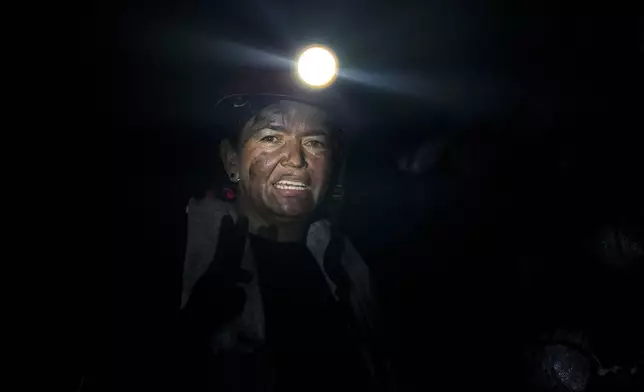 Emerald miner Janeth Paez stands inside the tunnel of an informal mine near the town of Coscuez, Colombia, on Feb. 28, 2024. (AP Photo/Fernando Vergara)