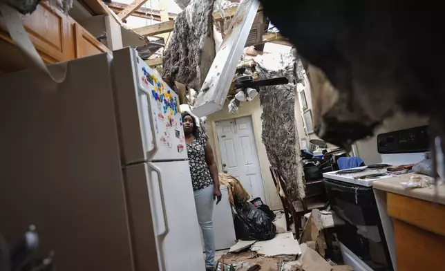 Natasha Ducre surveys the kitchen of her devastated home, which lost most of its roof during the passage of Hurricane Milton, in Palmetto, Fla., on Oct. 10, 2024. (AP Photo/Rebecca Blackwell)