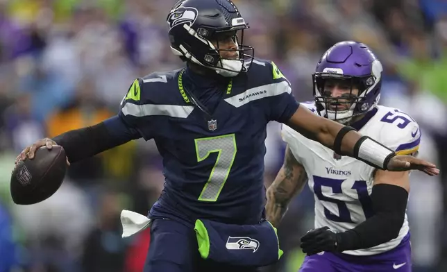 Seattle Seahawks quarterback Geno Smith (7) looks to pass while pressured by Minnesota Vikings linebacker Blake Cashman (51) during the second half of an NFL football game, Sunday, Dec. 22, 2024, in Seattle. (AP Photo/Lindsey Wasson)