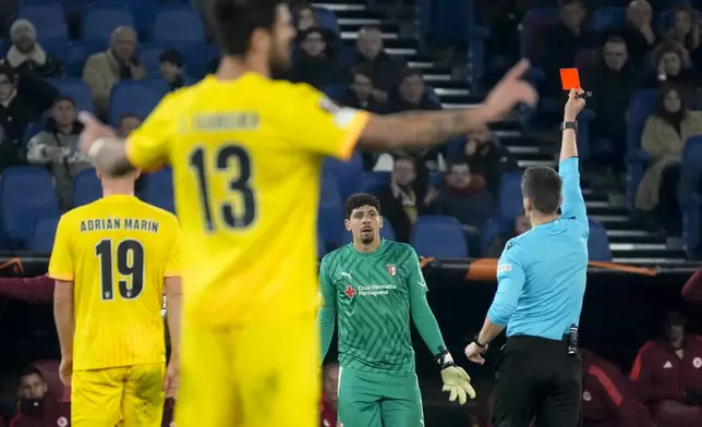 Braga's goalkeeper Matheus Magalhaes sees the red card after deflecting the ball with his arm outside the penalty box during the Europa League Soccer match between Roma and Braga at Rome's Olympic stadium, Thursday, Dec. 12, 2024. (AP Photo/Gregorio Borgia)