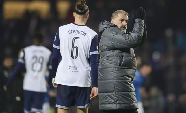 Tottenham's head coach Ange Postecoglou applauds the crowd after the Europa League opening phase soccer match between Glasgow Rangers and Tottenham Hotspur at Ibrox stadium in Glasgow, Thursday, Dec. 12, 2024. (AP Photo/Scott Heppell)