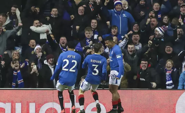 Rangers' Hamza Igamane, right, celebrates after scoring the opening goal during the Europa League opening phase soccer match between Glasgow Rangers and Tottenham Hotspur at Ibrox stadium in Glasgow, Thursday, Dec. 12, 2024. (AP Photo/Scott Heppell)