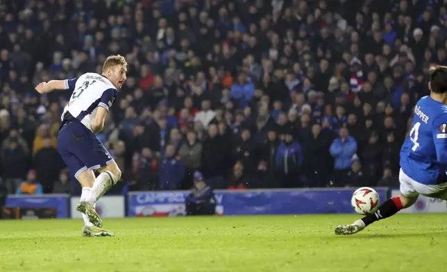 Tottenham Hotspur's Dejan Kulusevski scores their side's first goal of the game against Rangers during a UEFA Europa League soccer match at the Ibrox Stadium, Thursday, Dec. 12, 2024, in Glasgow, Scotland. (Steve Welsh/PA via AP)