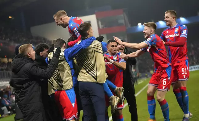 Plzen's Matej Vydra, top left, celebrates after scoring his side's opening goal during the Europa League soccer match between Viktoria Plzen and Manchester United at the Doosan Arena in Plzen, Czech Republic, Thursday, Dec. 12, 2024. (AP Photo/Petr David Josek)