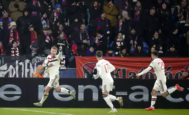 Manchester United's Rasmus Hojlund, left, celebrates after scoring during the Europa League soccer match between Viktoria Plzen and Manchester United at the Doosan Arena in Plzen, Czech Republic, Thursday, Dec. 12, 2024. (AP Photo/Petr David Josek)