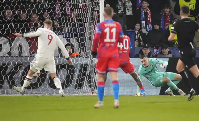 Manchester United's Rasmus Hojlund, left, scores his side's opening goal during the Europa League soccer match between Viktoria Plzen and Manchester United at the Doosan Arena in Plzen, Czech Republic, Thursday, Dec. 12, 2024. (AP Photo/Petr David Josek)