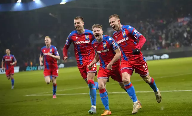 Plzen's Matej Vydra, right, celebrates with teammates after scoring his side's opening goal during the Europa League soccer match between Viktoria Plzen and Manchester United at the Doosan Arena in Plzen, Czech Republic, Thursday, Dec. 12, 2024. (AP Photo/Petr David Josek)