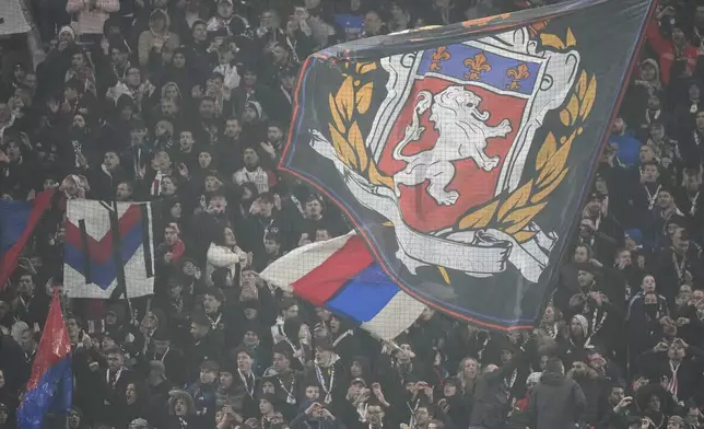 Lyon' supporters hold a giant flag during the Europa League soccer soccer match between Lyon and Eintracht Frankfurt at Decines stadium outside Lyon, France, Thursday, Dec. 12, 2024. (AP Photo/Michel Euler)