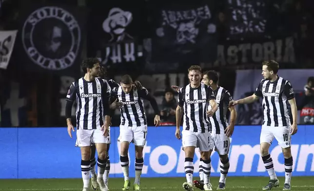 PAOK players celebrate a goal against Ferencvaros during the Europa League opening phase soccer match between PAOK and Ferencvaros at Toumpa stadium, in Thessaloniki, Greece, Thursday, Dec. 12, 2024. (AP Photo/Giannis Papanikos)