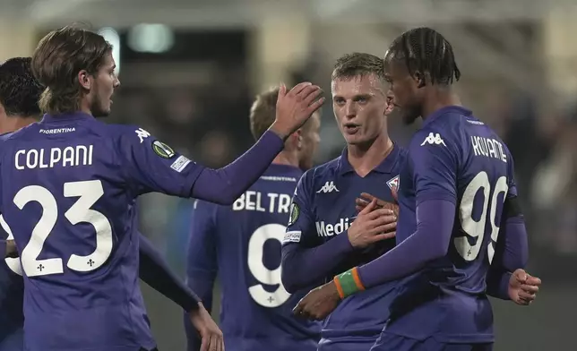 Fiorentina's Albert Gudmundsson, centre right, celebrates with teammates after scroing his side's seventh goal during the Europa Conference League opening phase soccer match between Fiorentina and LASK at the Artemio Franchi Stadium in Florence, Italy, Thursday Dec. 12, 2024. (Massimo Paolone/LaPresse via AP)