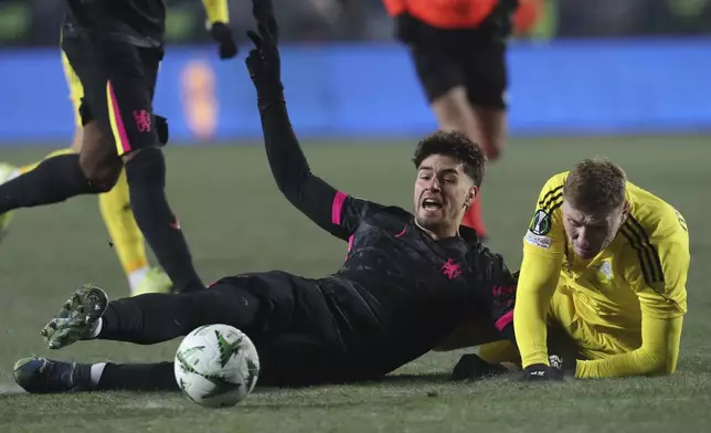 Chelsea's Marc Guiu, left, fights for the ball with Astana's Alexandr Marochkin during the Europa Conference League opening phase soccer match between Astana and Chelsea at the Almaty Ortalyk stadium in Almaty, Kazakhstan, Thursday, Dec. 12, 2024. (AP Photo)