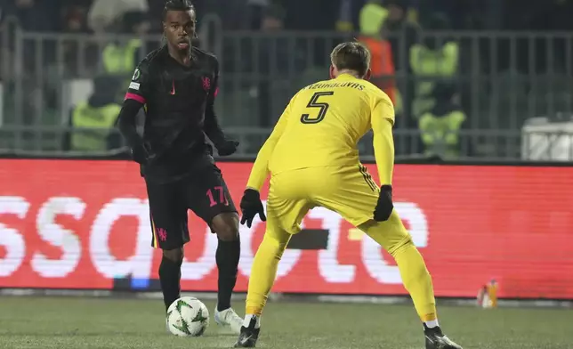 Chelsea's Carney Chukwuemeka, left, fights for the ball with Astana's Kipras Kazukolovas during the Europa Conference League opening phase soccer match between Astana and Chelsea at the Almaty Ortalyk stadium in Almaty, Kazakhstan, Thursday, Dec. 12, 2024. (AP Photo)