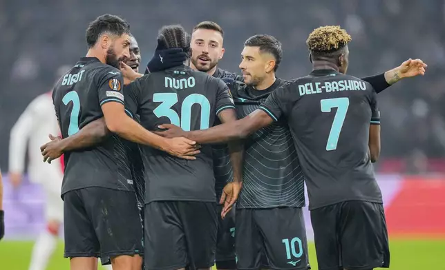 Lazio players celebrate their third team goal during the Europa League soccer match between Ajax and Lazio Roma at the Johan Cruyff Arena in Amsterdam, Netherlands, Thursday, Dec. 12, 2024. (AP Photo/Peter Dejong)