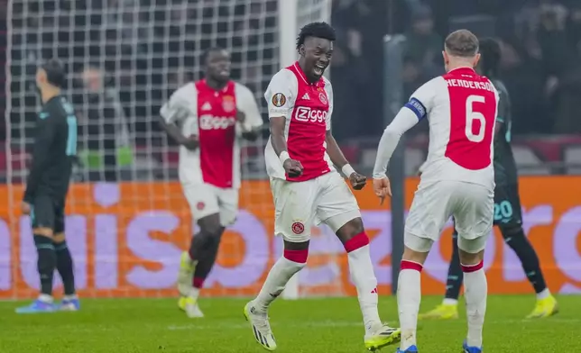 Ajax's Bertrand Traore, centre, celebrates after scoring during the Europa League soccer match between Ajax and Lazio Roma at the Johan Cruyff Arena in Amsterdam, Netherlands, Thursday, Dec. 12, 2024. (AP Photo/Peter Dejong)