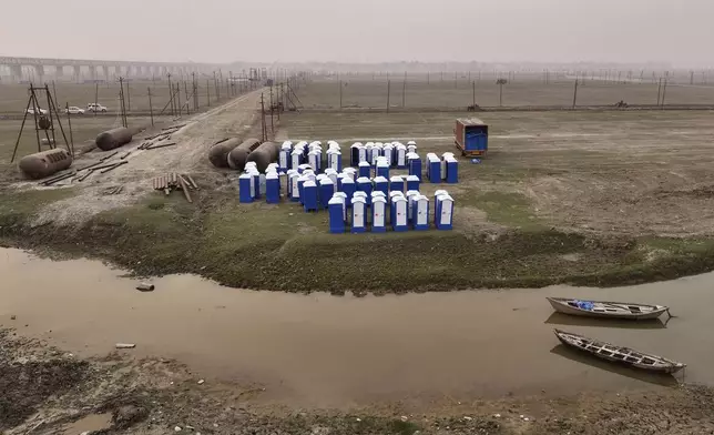 Portable toilets are kept on the banks of the Ganges river before installation, in preparation for the upcoming Maha Kumbh Mela, one of the world's largest religious festivals, in Prayagraj, India, Friday, Nov. 29, 2024. (AP Photo/Rajesh Kumar Singh)