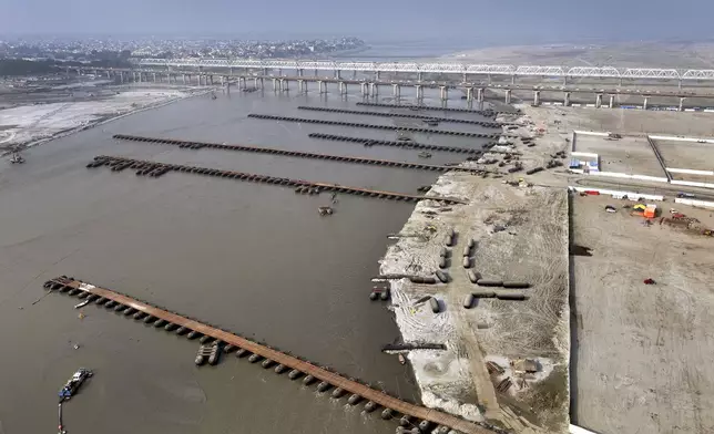 Workers build pontoon bridges over the Ganges river in preparation for the upcoming Maha Kumbh Mela, one of the world's largest religious festivals, in Prayagraj, India, Wednesday, Nov. 27, 2024. (AP Photo/Rajesh Kumar Singh)