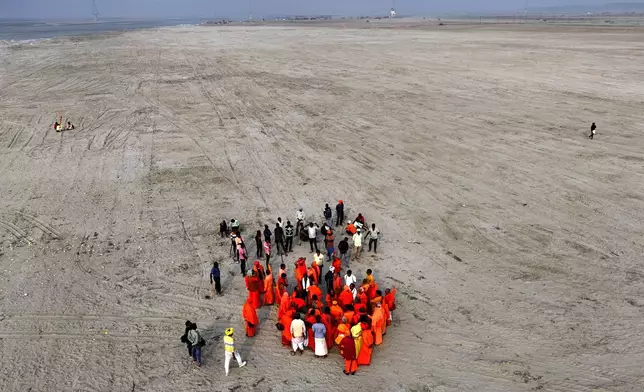 Hindu holy men, or Sadhus, inspect a site for their camp on the banks of the Ganges river for the upcoming Maha Kumbh Mela, one of the world's largest religious festivals, in Prayagraj, India, Friday, Nov. 22, 2024. (AP Photo/Rajesh Kumar Singh)