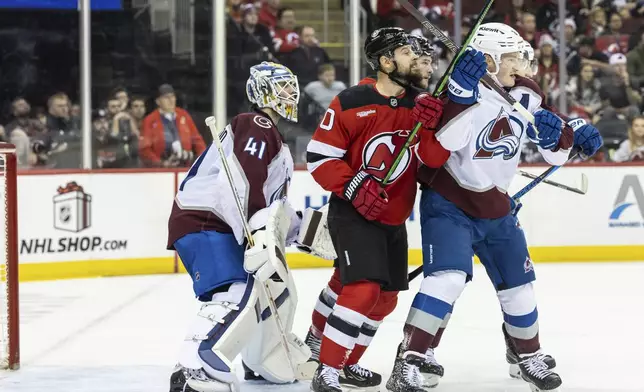 Colorado Avalanche goalie Scott Wedgewood (41) looks out during the second period of an NHL hockey game against the New Jersey Devils, Sunday, Dec. 8, 2024, in Newark, N.J. (AP Photo/Stefan Jeremiah)
