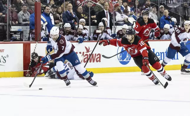 Colorado Avalanche defenseman Devon Toews (7) skates with the puck during the second period of an NHL hockey game against the New Jersey Devils, Sunday, Dec. 8, 2024, in Newark, N.J. (AP Photo/Stefan Jeremiah)