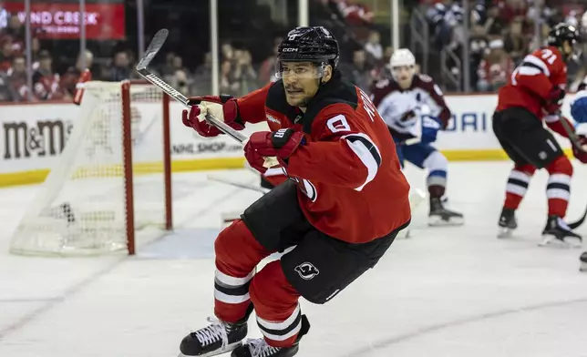 New Jersey Devils defenseman Johnathan Kovacevic chases the puck during the first period of an NHL hockey game against the Colorado Avalanche, Sunday, Dec. 8, 2024, in Newark, N.J. (AP Photo/Stefan Jeremiah)