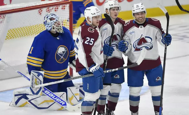 Colorado Avalanche left wing Joel Kiviranta, second from right, celebrates with right wingers Nikolai Kovalenko, right, and Logan O'Connor (25) after scoring during the third period of an NHL hockey game against the Buffalo Sabres in Buffalo, N.Y., Tuesday, Dec. 3, 2024. (AP Photo/Adrian Kraus)