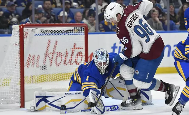 Buffalo Sabres goalie Ukko-Pekka Luukkonen (1) makes a save against Colorado Avalanche right wing Mikko Rantanen (96) during the first period of an NHL hockey game in Buffalo, N.Y., Tuesday, Dec. 3, 2024. (AP Photo/Adrian Kraus)