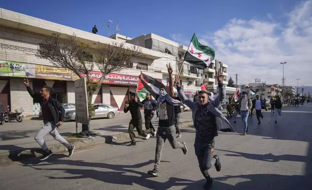 FILE - Syrians celebrate the fall of Bashar Assad's government in the town of Bar Elias, Lebanon, near the border with Syria, Sunday, Dec. 8, 2024. (AP Photo/Hassan Ammar, File)