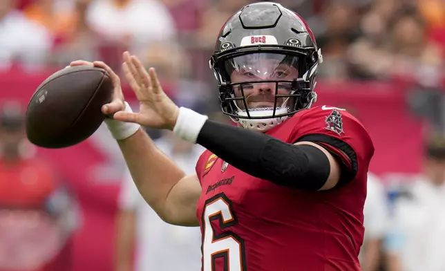 Tampa Bay Buccaneers quarterback Baker Mayfield passes for a touchdown against the Carolina Panthers during the first half of an NFL football game Sunday, Dec. 29, 2024, in Tampa, Fla. (AP Photo/Chris O'Meara)