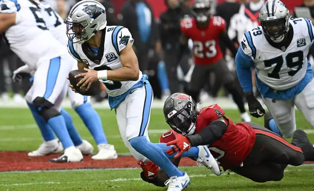 Carolina Panthers quarterback Bryce Young is sacked by Tampa Bay Buccaneers linebacker Yaya Diaby during the second half of an NFL football game Sunday, Dec. 29, 2024, in Tampa, Fla. (AP Photo/Jason Behnken)