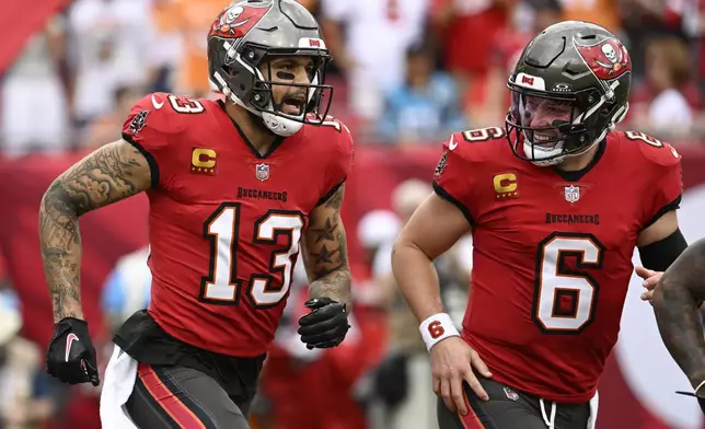 Tampa Bay Buccaneers wide receiver Mike Evans celebrates after scoring with quarterback Baker Mayfield against the Carolina Panthers during the first half of an NFL football game Sunday, Dec. 29, 2024, in Tampa, Fla. (AP Photo/Jason Behnken)