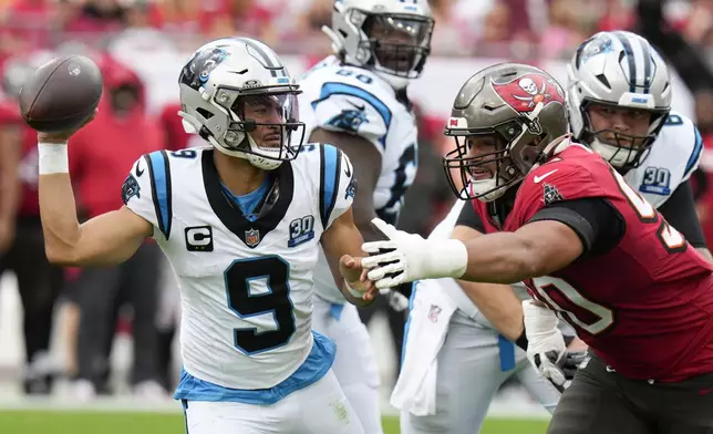 Carolina Panthers quarterback Bryce Young passes under pressure from Tampa Bay Buccaneers defensive end Logan Hall during the first half of an NFL football game Sunday, Dec. 29, 2024, in Tampa, Fla. (AP Photo/Chris O'Meara)