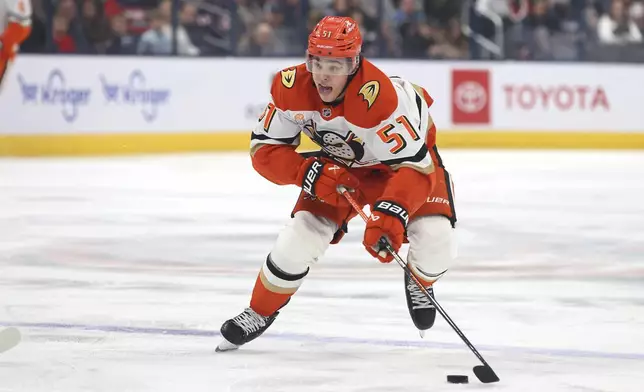 Anaheim Ducks defenseman Olen Zellweger brings the puck up the ice against the Columbus Blue Jackets during the first period of an NHL hockey game Saturday, Dec. 14, 2024, in Columbus, Ohio. (AP Photo/Joe Maiorana)