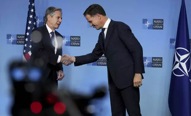 NATO Secretary General Mark Rutte, right, shakes hands with United States Secretary of State Antony Blinken during a meeting of NATO foreign ministers at NATO headquarters in Brussels,Tuesday, Dec. 3, 2024. (AP Photo/Virginia Mayo)