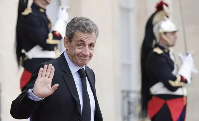 FILE - Former French President Nicolas Sarkozy leaves the Elysee Palace after a lunch with heads of states and officials, Monday, Sept. 30, 2019 in Paris. (AP Photo/Kamil Zihnioglu, File)